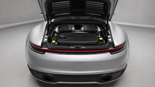 Porsche 992 Carrera rear engine bay with the engine lid open and intercoolers visible.