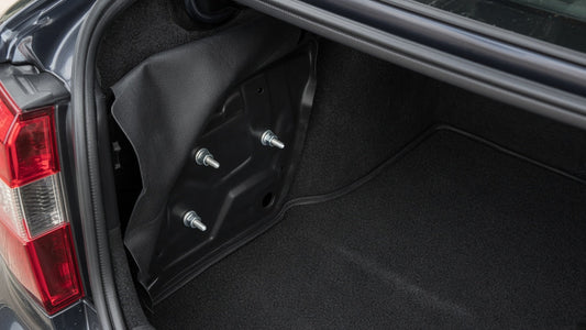 Open trunk with the liner pulled back from an outer tail lamp
