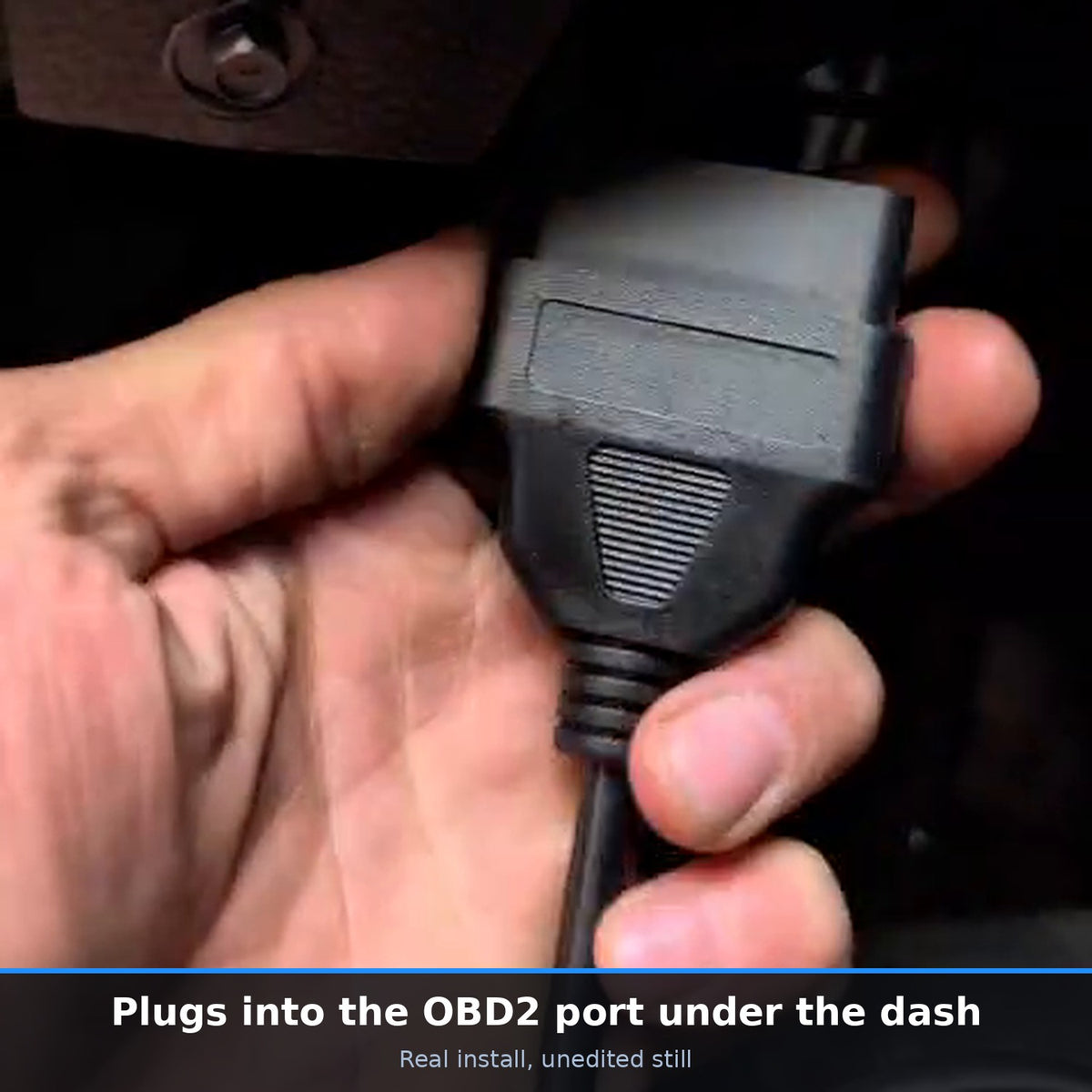 Plugging the performance chip cable into the OBD2 port under the dash