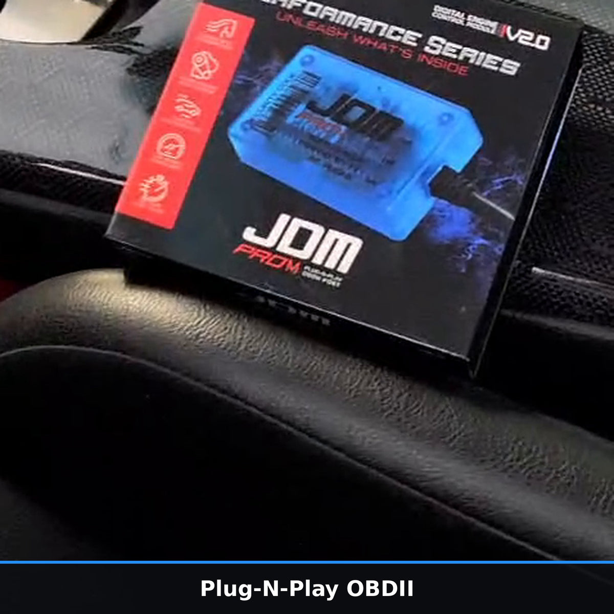 Plug-N-Play OBDII performance chip box on a car console