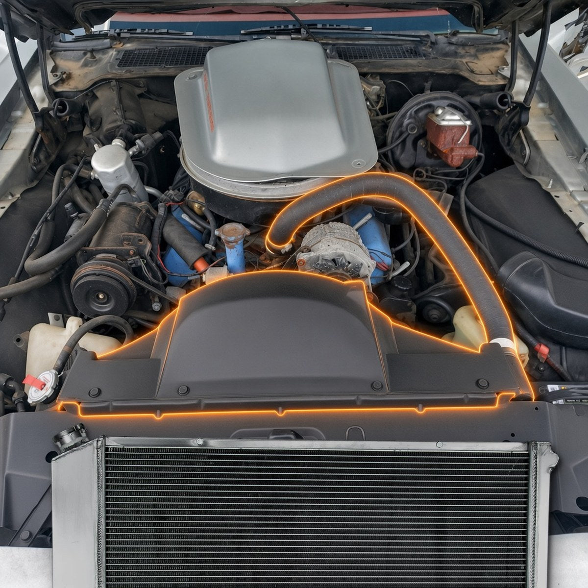 1979 Pontiac Firebird Trans Am engine bay with the radiator area highlighted and the aluminum performance radiator that fits it
