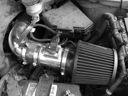 Car air intake system with metallic and rubber components.