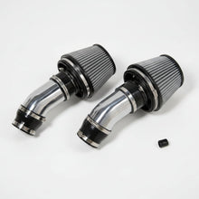 Two chrome air filters on a white background