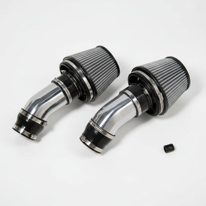 Two chrome air filters on a white background