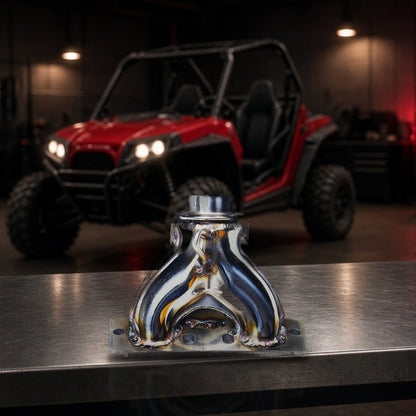 Manifold Exhaust System For Polaris RZR (2009-2010) Aftermarket Stainless on a garage workbench