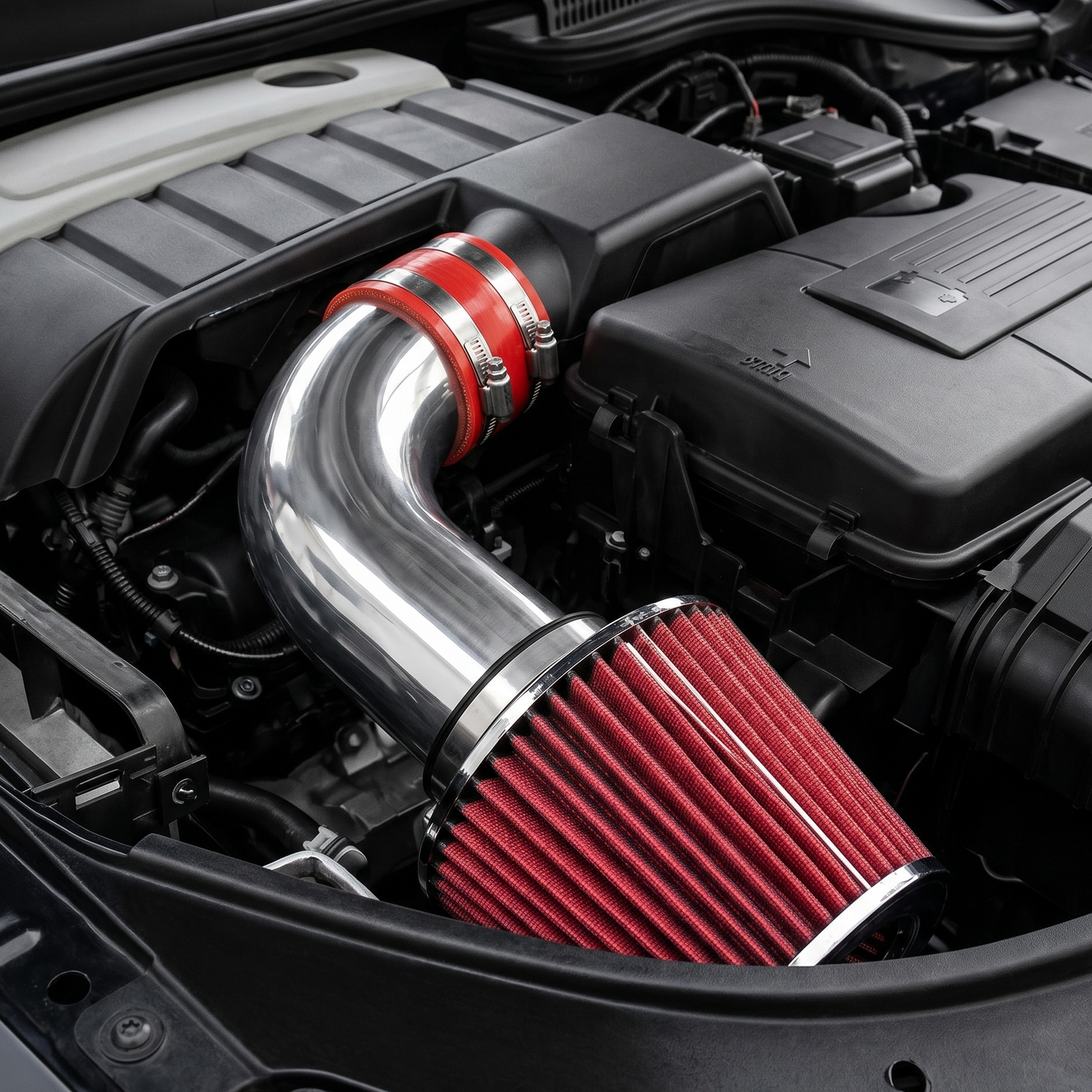 Car engine with a metallic air intake system and red filter
