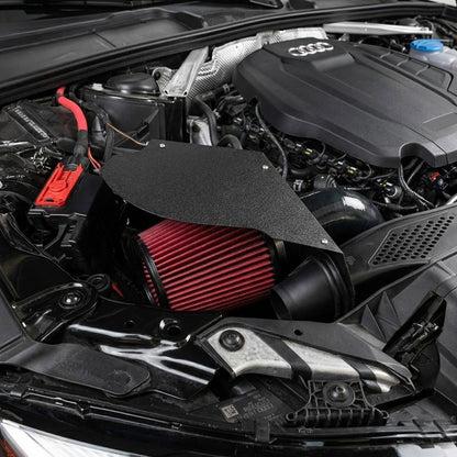 Car engine with a red air filter and Audi logo visible