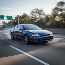 A square image of a Chevy Monte Carlo (2006-2008) driving fast showing speed
