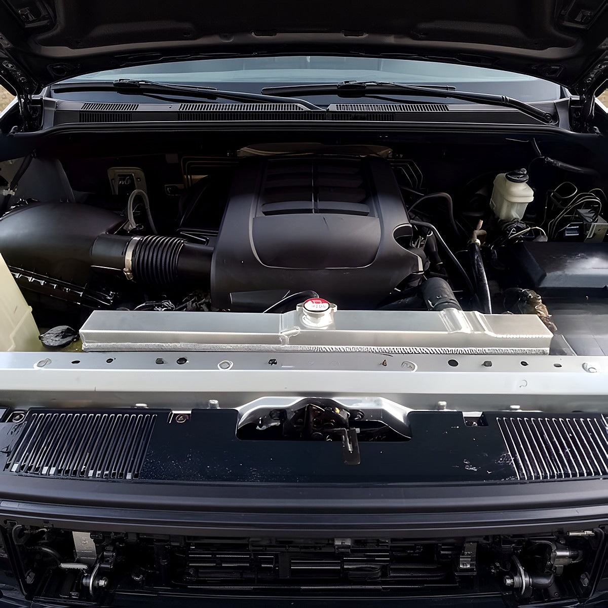 Aluminum performance radiator installed in a 2007-2020 Toyota Tundra 5.7L V8 engine bay, front view