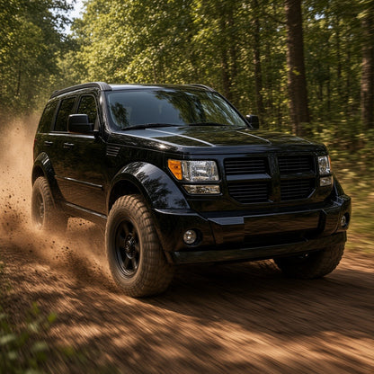 Black Dodge Nitro driving off-road on a forest trail