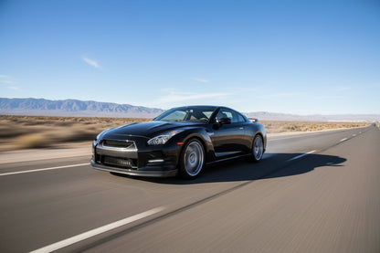 Black Nissan GT-R R35 driving fast on a desert highway