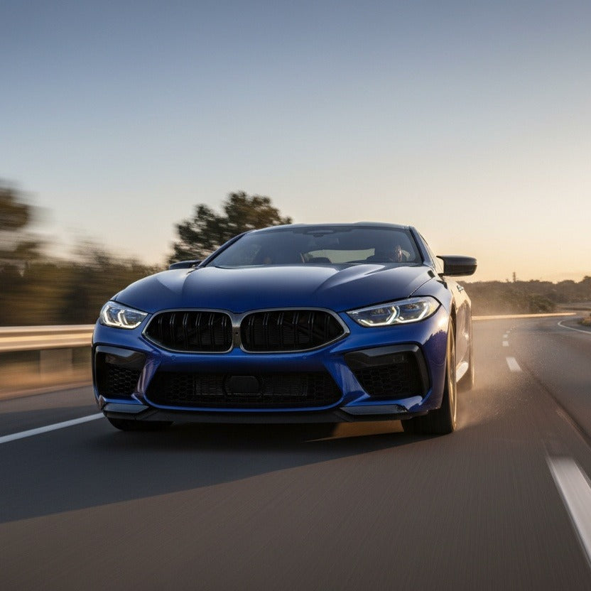 Blue BMW M8 driving on a highway
