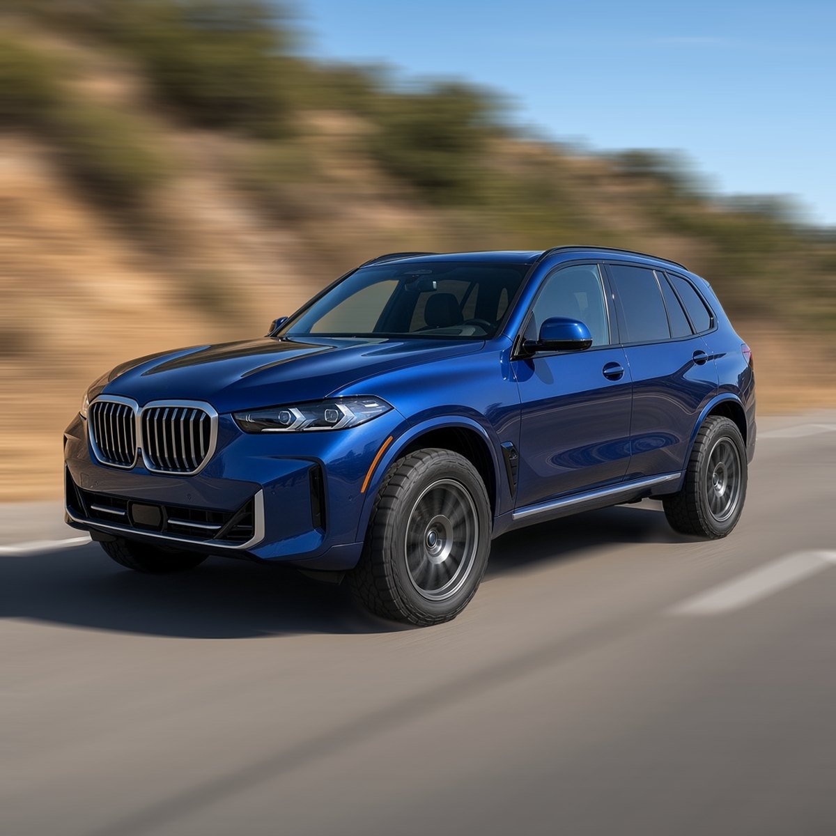 Blue BMW X5 SUV with off-road wheels driving fast