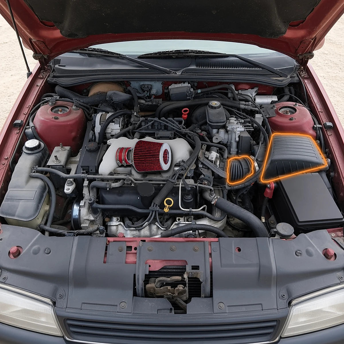 Cold air intake shown over a 1994-1996 Chevy Corsica 3100 V6 engine bay, stock airbox and intake duct it replaces highlighted in orange