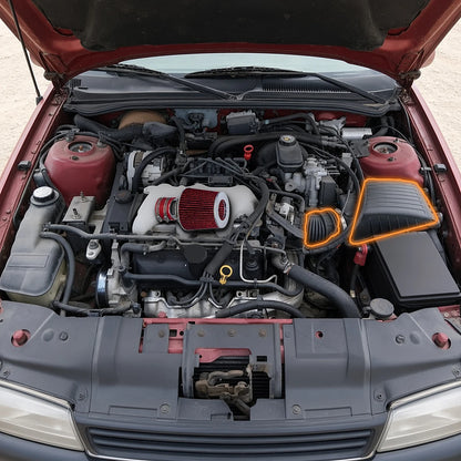 Cold air intake shown over a 1994-1996 Chevy Corsica 3100 V6 engine bay, stock airbox and intake duct it replaces highlighted in orange