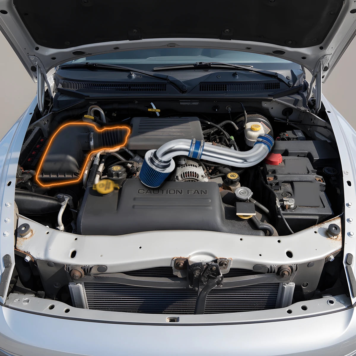 Dodge Dakota and Durango 4.7L engine bay with blue cold air intake kit over the engine, stock airbox and intake tube highlighted for replacement