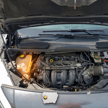 2014-2018 Ford Transit Connect 2.5L engine bay with the factory coolant expansion tank highlighted and the replacement tank