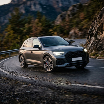 Grey Audi Q5 driving fast on a mountain road