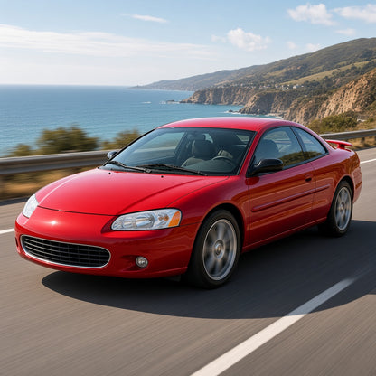 Red 2001-2005 Chrysler Sebring coupe driving fast on a coastal highway