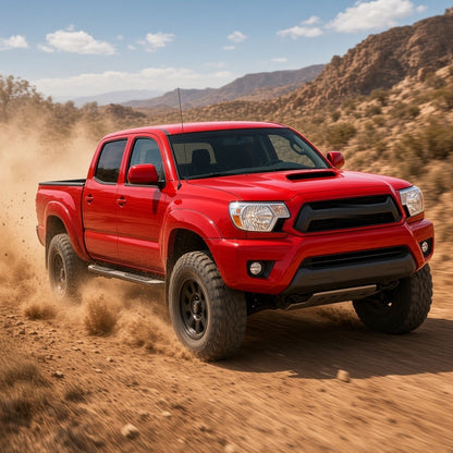 Red Toyota Tacoma driving off-road on a desert trail