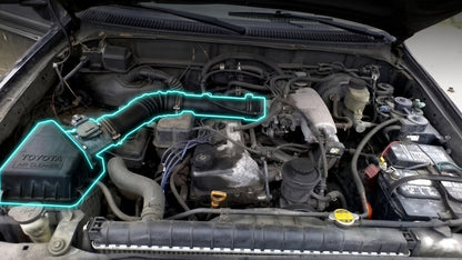 Toyota Tacoma 1999-2004 3.4L engine bay with the air box and intake pipe highlighted